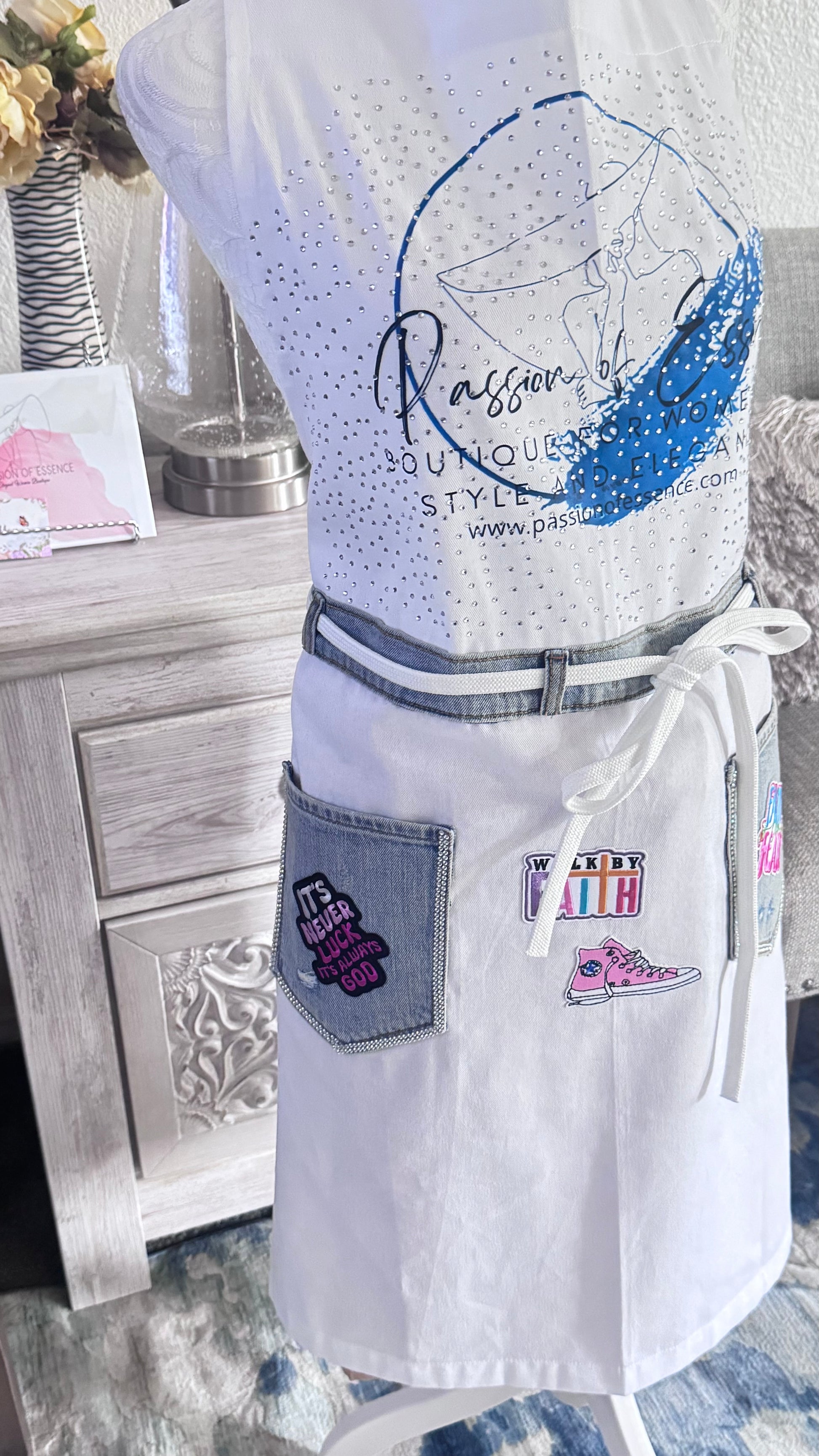 White apron with branding and design elements on a wooden surface