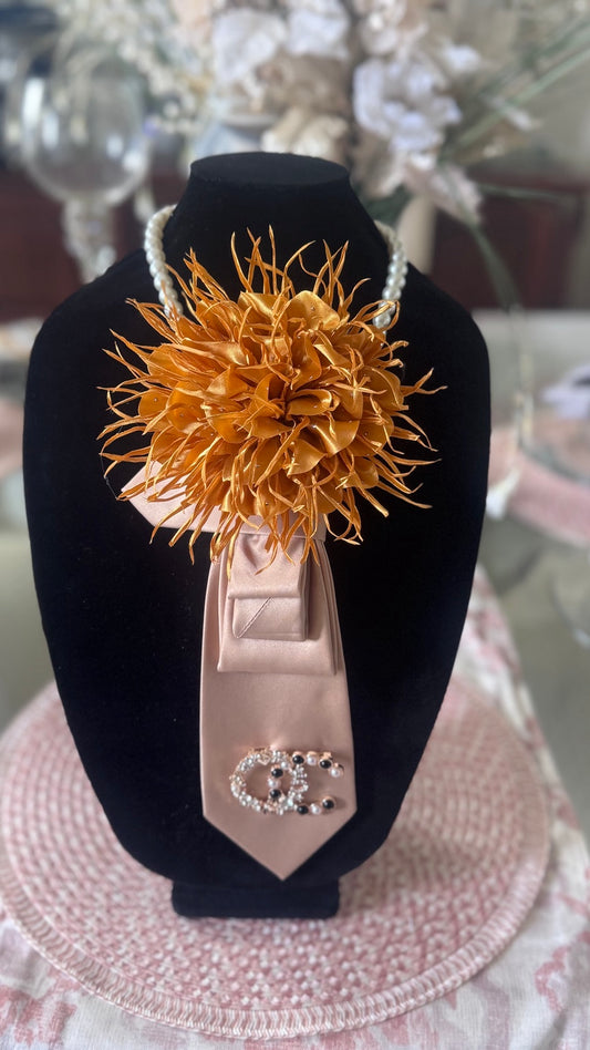 Gold flower accessory on a black stand with a blurred background