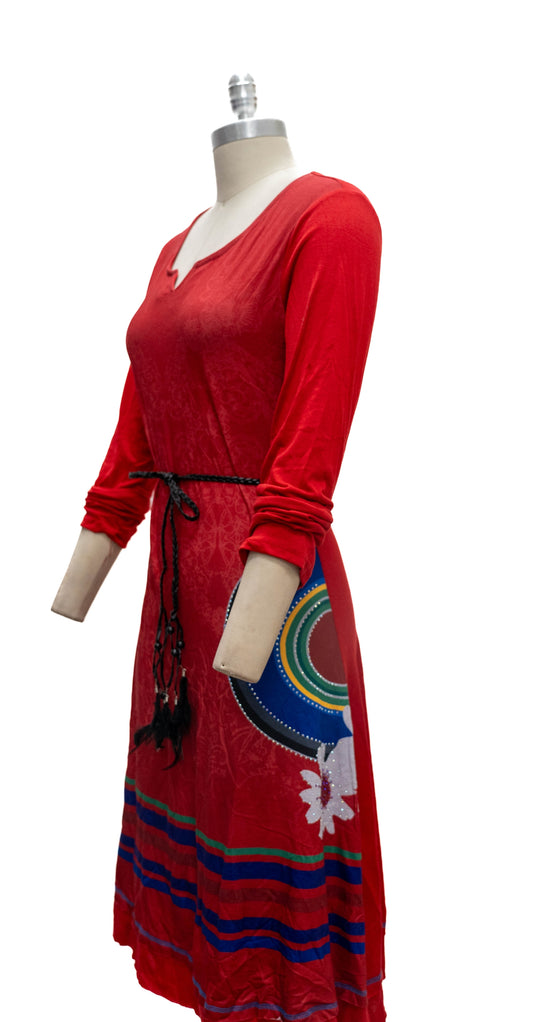 Red dress with colorful patterns on a mannequin against a white background