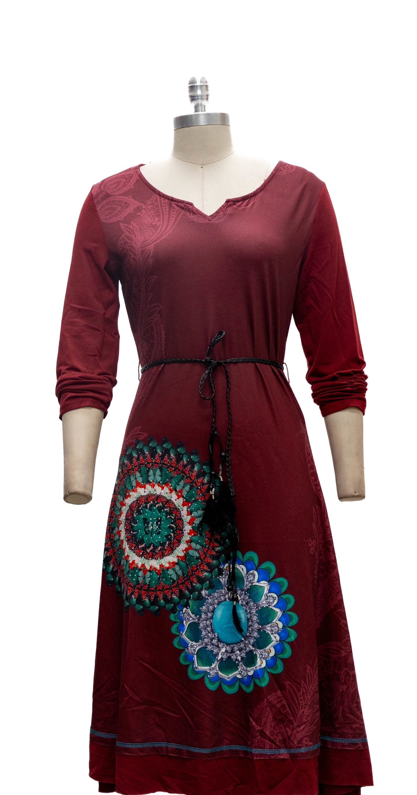 Red dress with intricate patterns on a mannequin against a white background