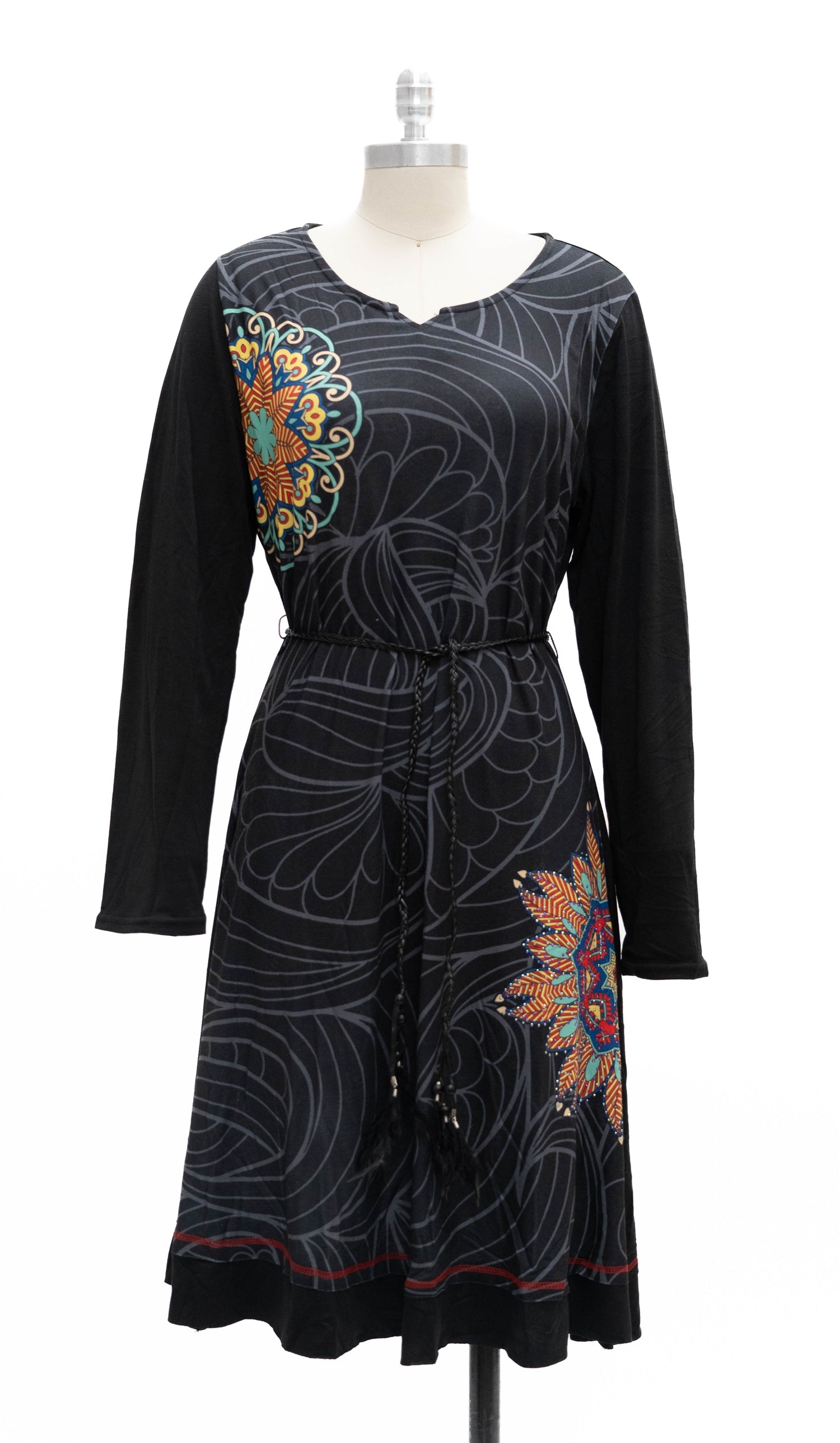 Black dress with colorful floral patterns on a mannequin against a white background