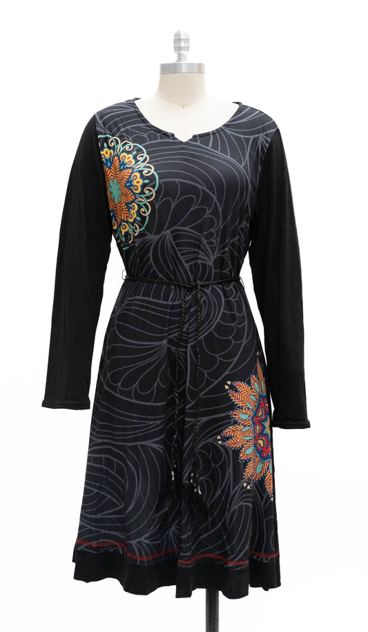 Black dress with colorful floral patterns on a mannequin against a white background