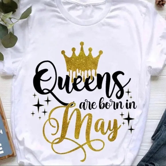 White t-shirt with 'Queens are born in May' text and gold crown graphic on a white background.