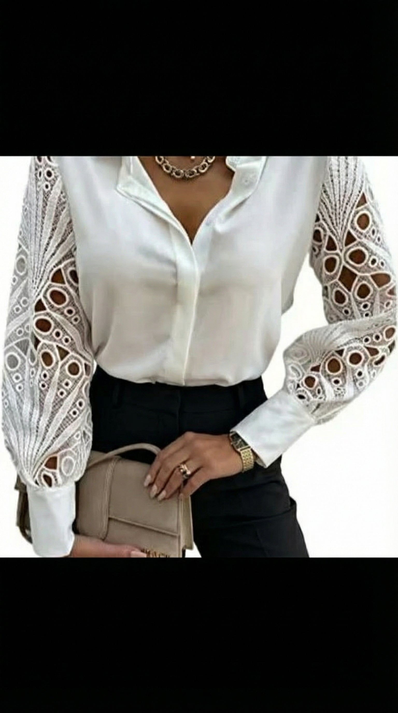 White blouse with lace sleeves worn by a person, holding a beige handbag.