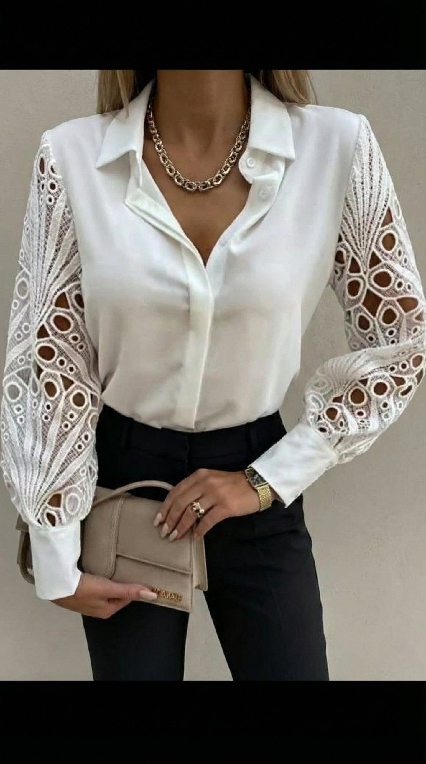 White blouse with lace sleeves worn by a person, holding a beige handbag.