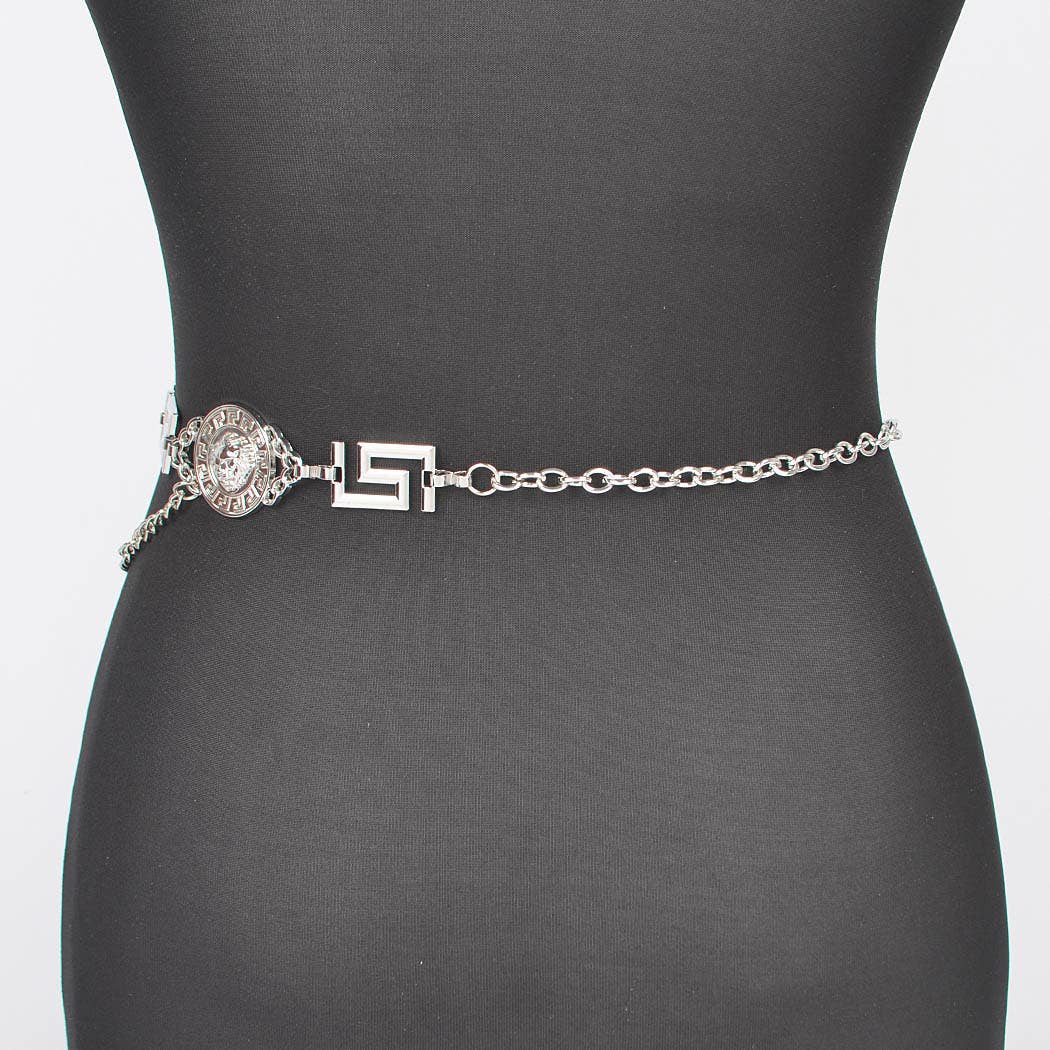 Silver chain belt with decorative clasp on a mannequin against a gray background