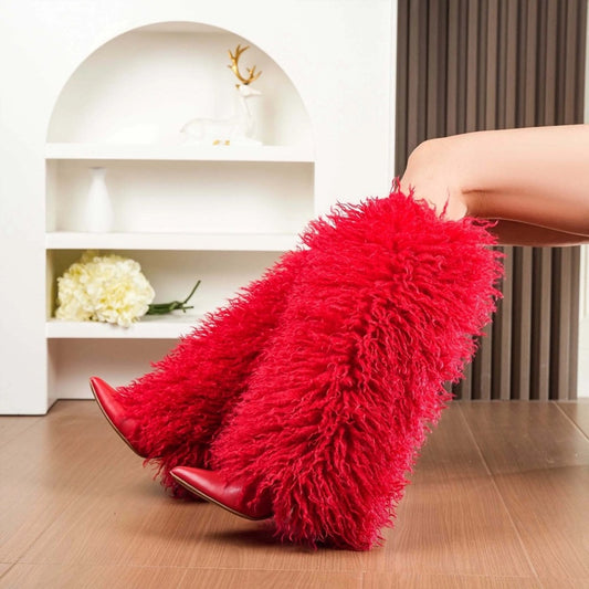 Red furry boots being worn indoors with a neutral background