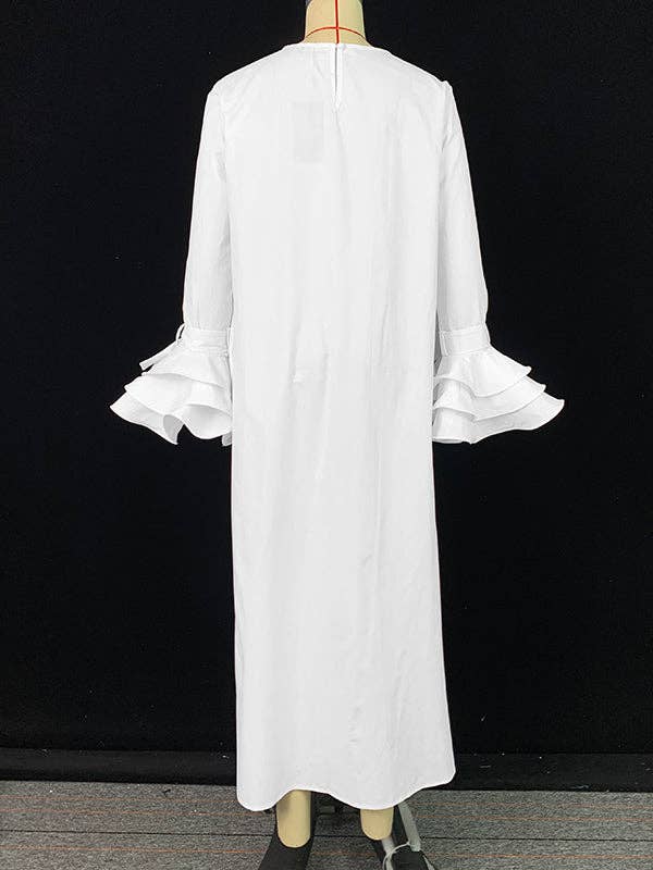 White dress with ruffled sleeves on a mannequin against a black background