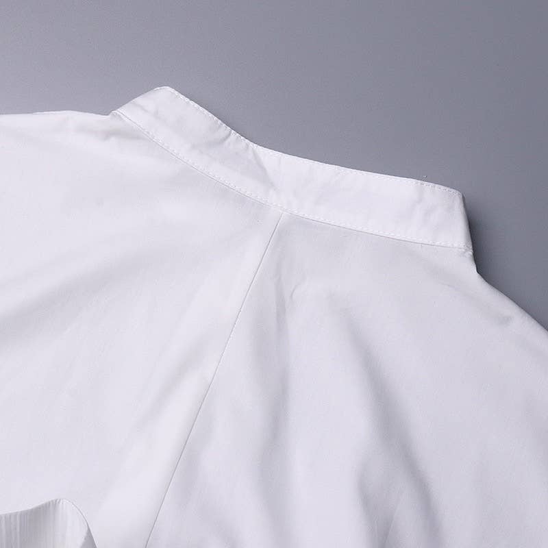 Close-up of a white shirt with a gray background