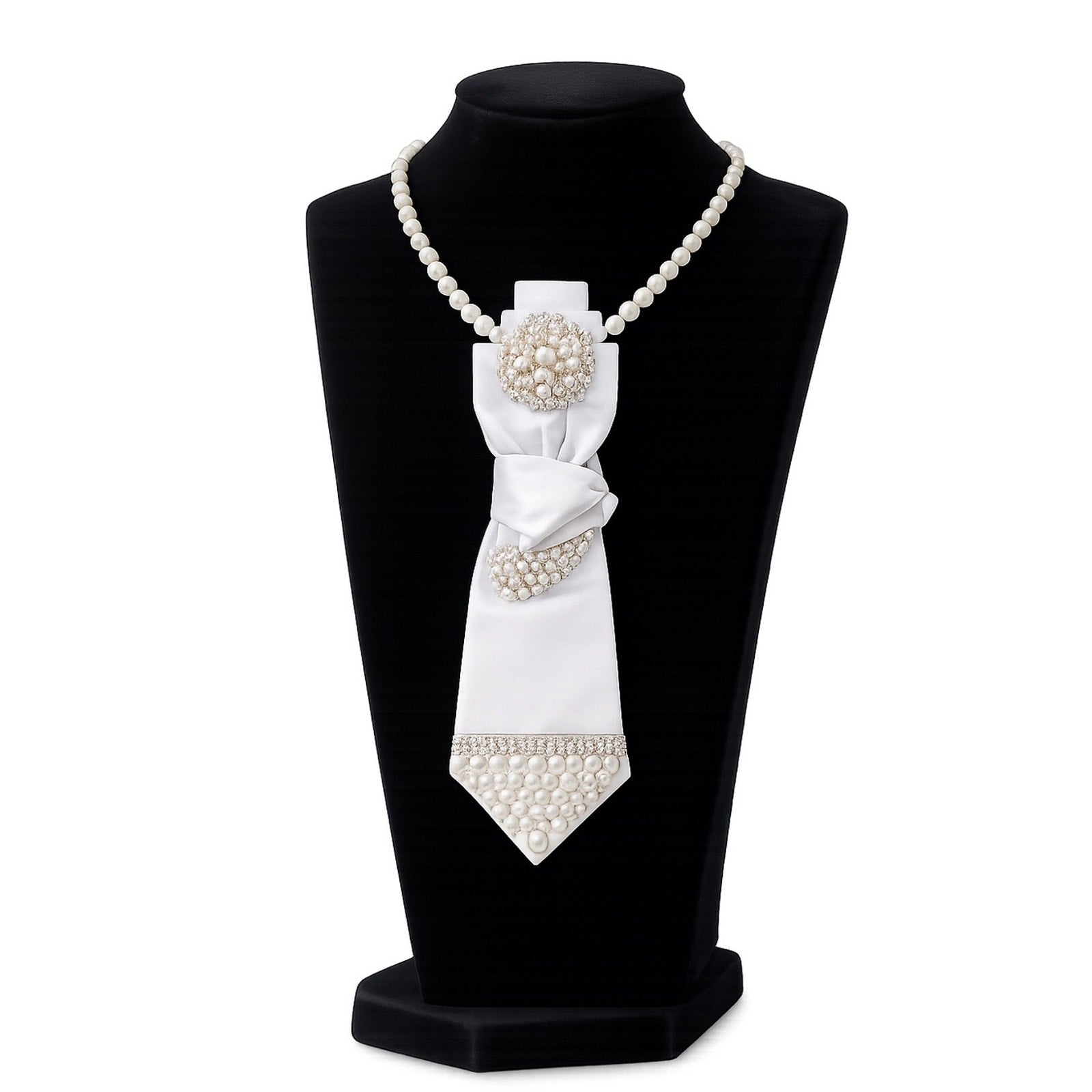White pearl tie and bow on a black mannequin bust with a white background