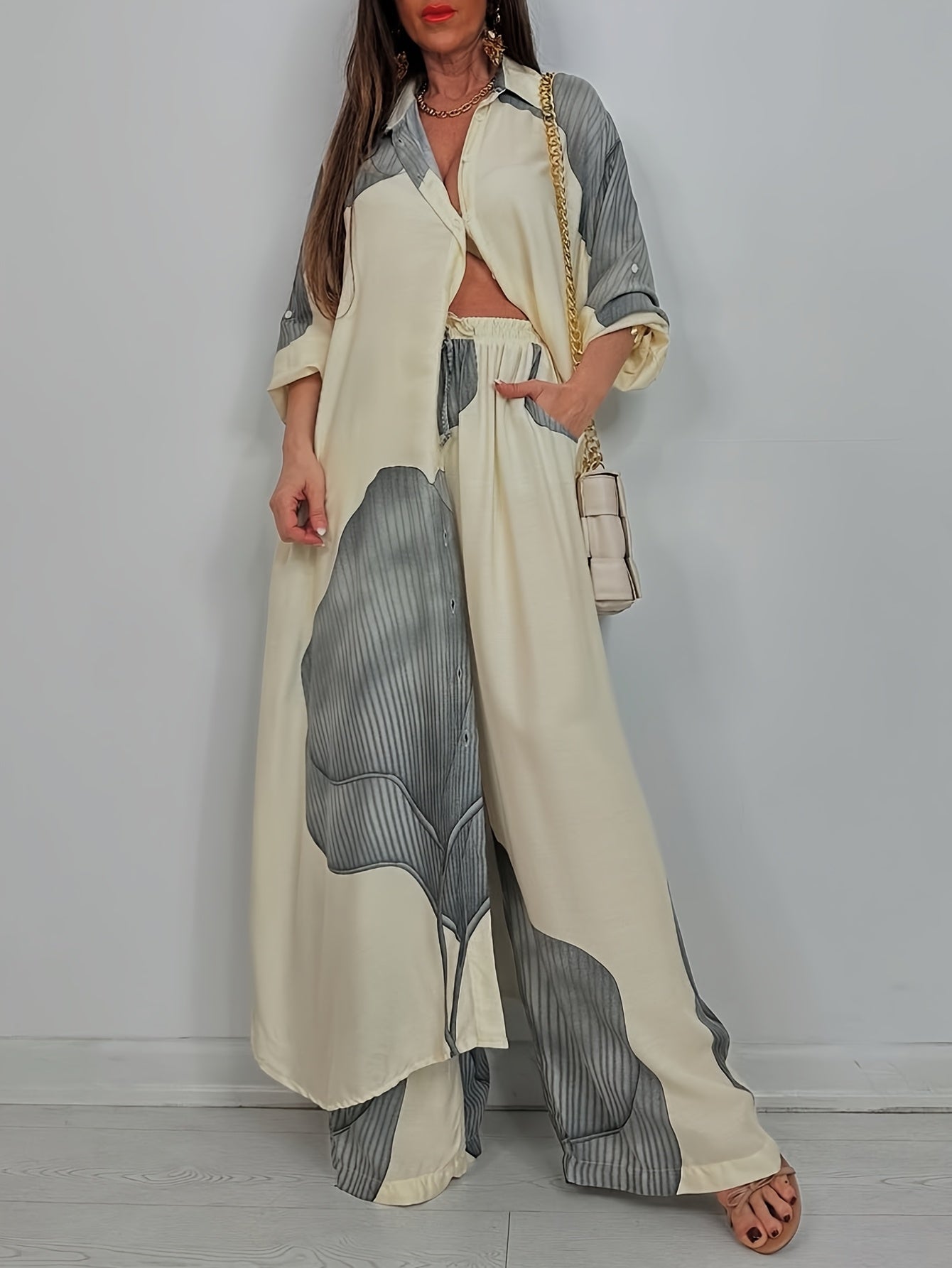 Woman wearing a long, patterned dress with a white background