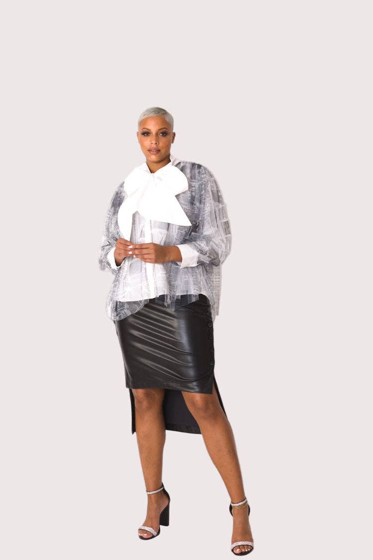 Woman wearing a silver blouse with a white collar and black leather skirt on a white background