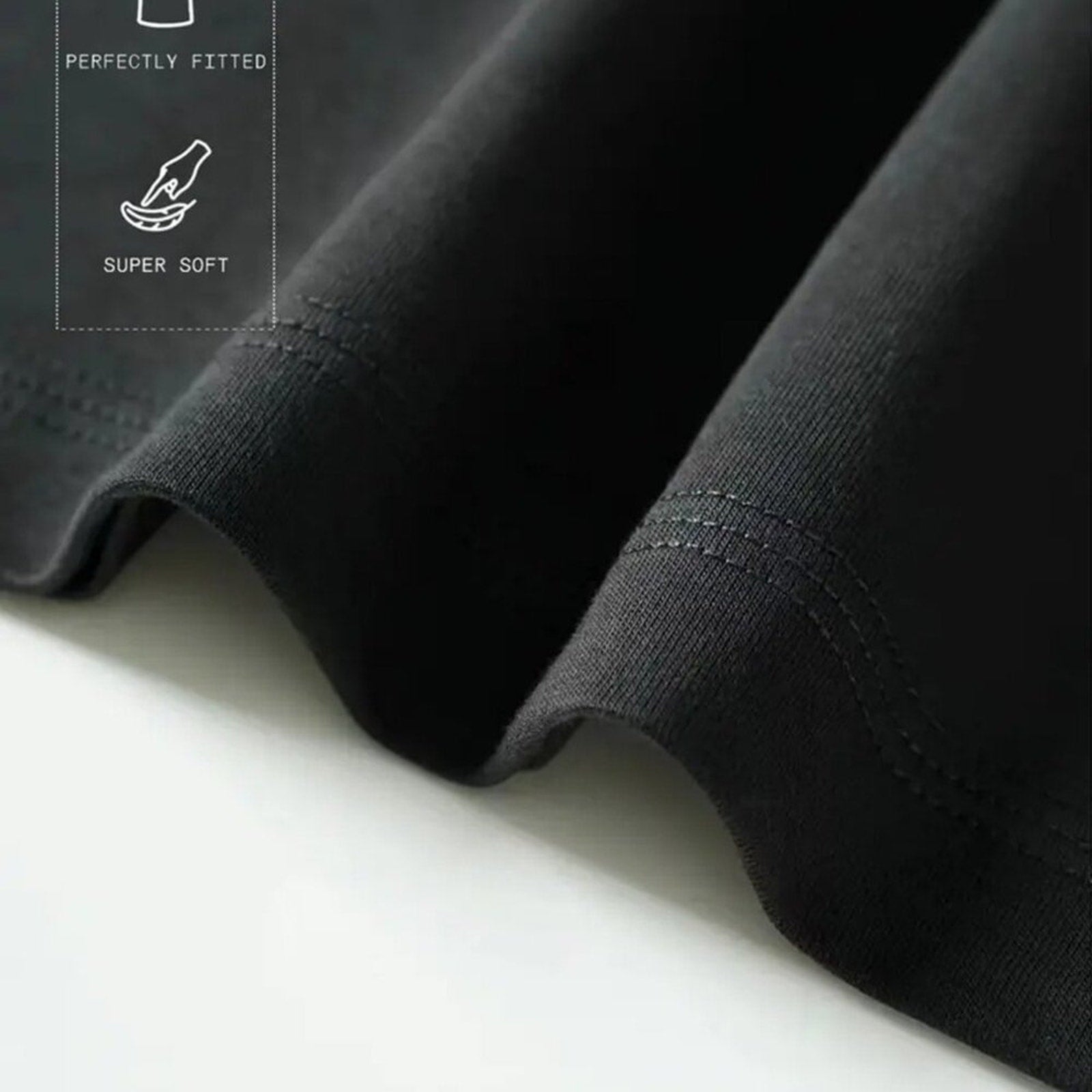 Close-up of black fabric with 'Perfectly Fitted' and 'Super Soft' text on a white background