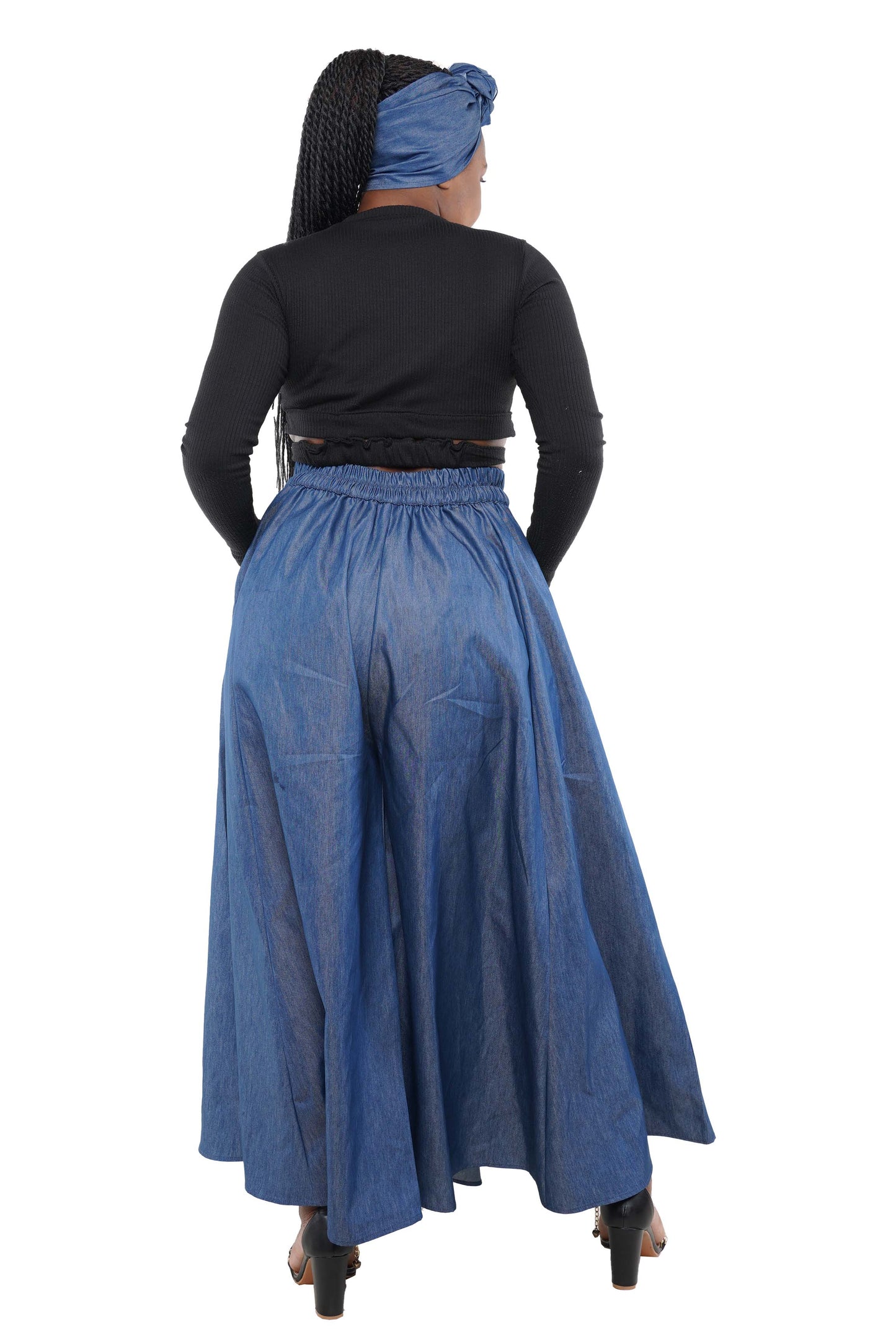 Person wearing a black top and blue denim skirt with a headscarf on a white background