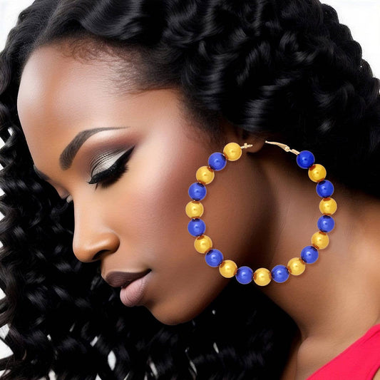 Woman wearing colorful hoop earrings with a close-up focus on the jewelry.