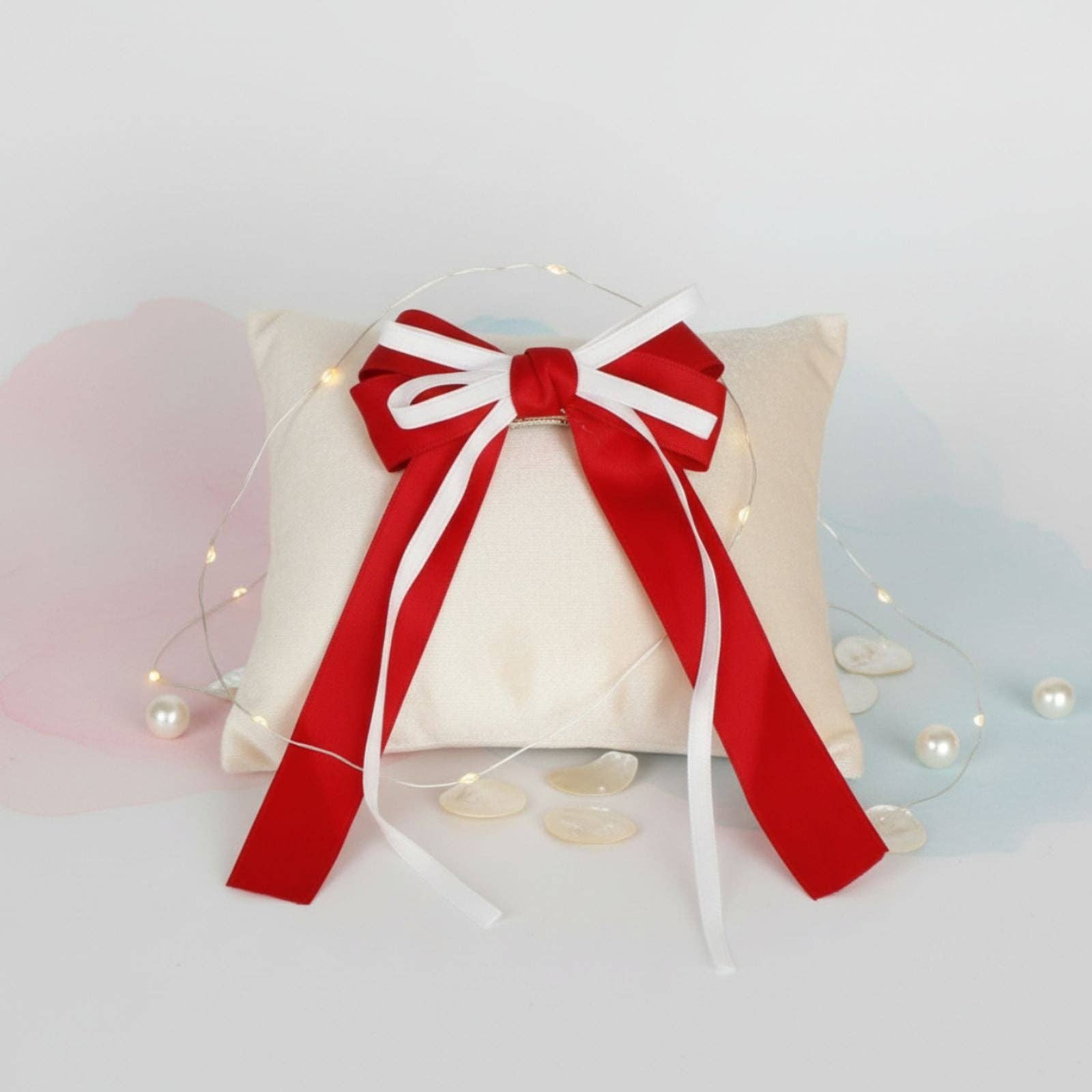 Decorative pillow with a large red bow on a light background
