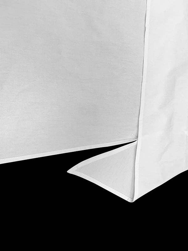 Close-up of a white corner with a black base