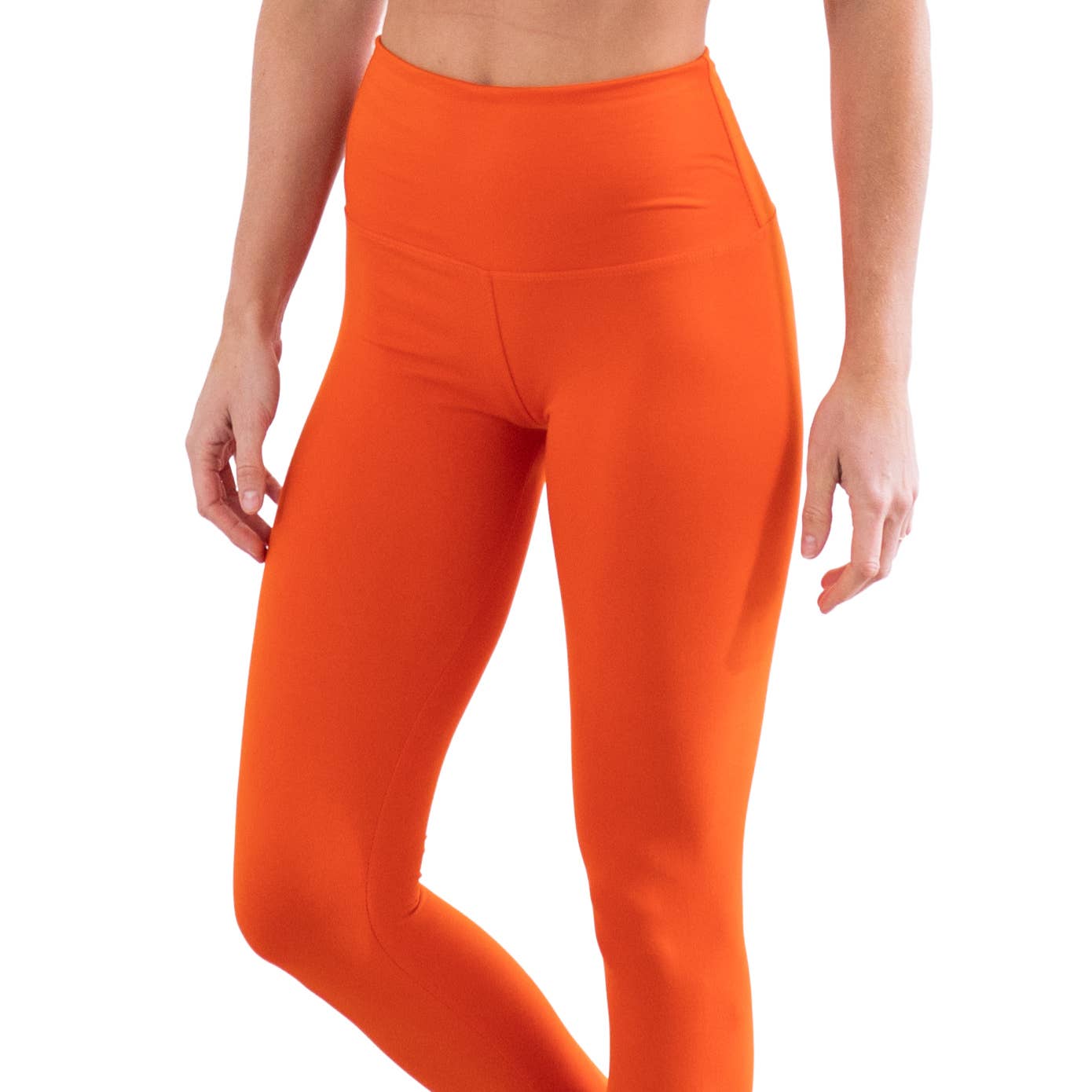 Orange leggings worn by a person on a white background