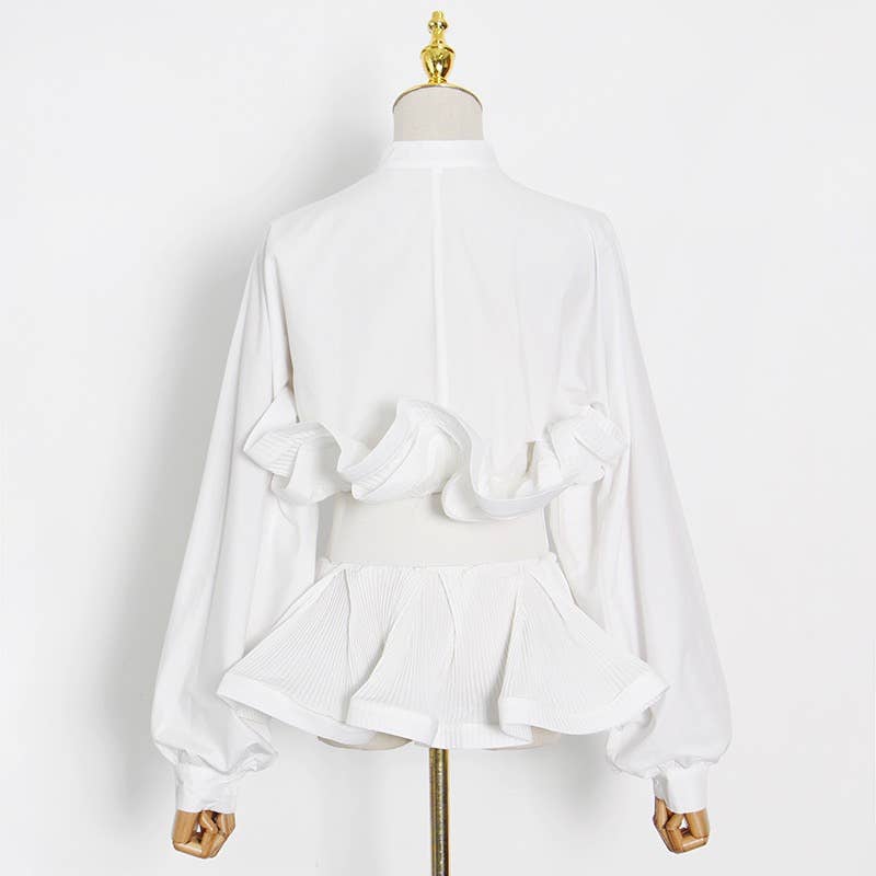 White blouse with bow details on a mannequin against a white background