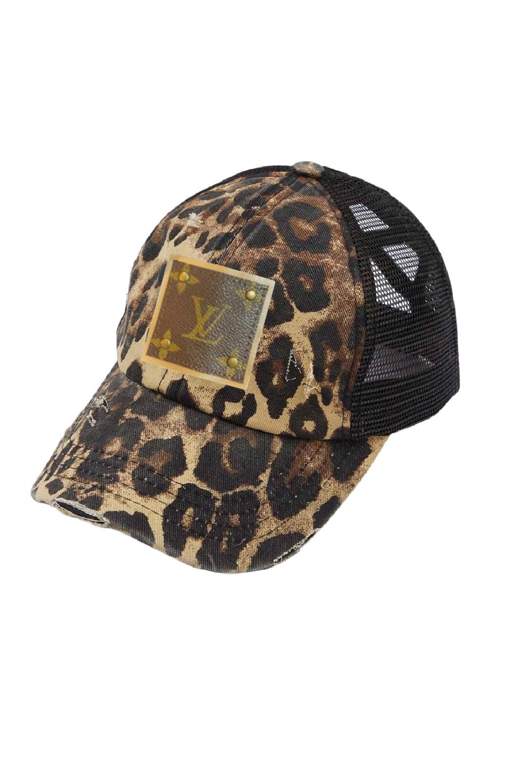 Leopard print baseball cap with a brand logo on a white background
