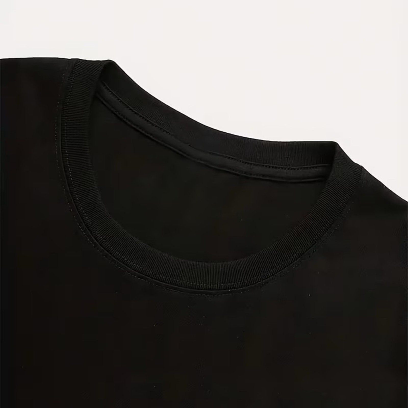 Close-up of a black t-shirt collar on a white background