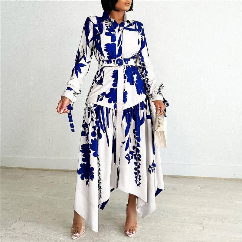 Woman wearing a white dress with blue floral patterns against a plain background
