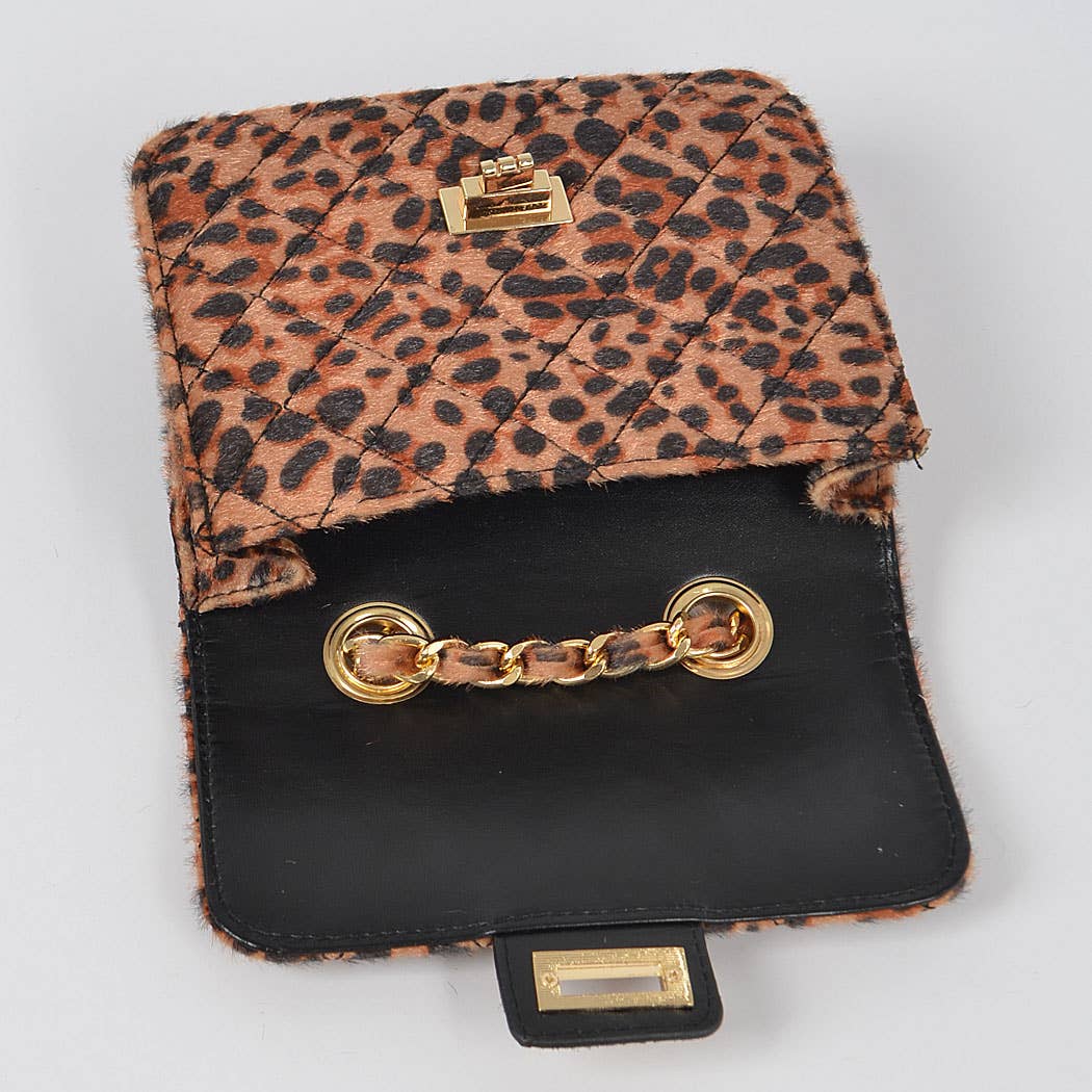Leopard print wallet with black interior and gold accents on a light gray background
