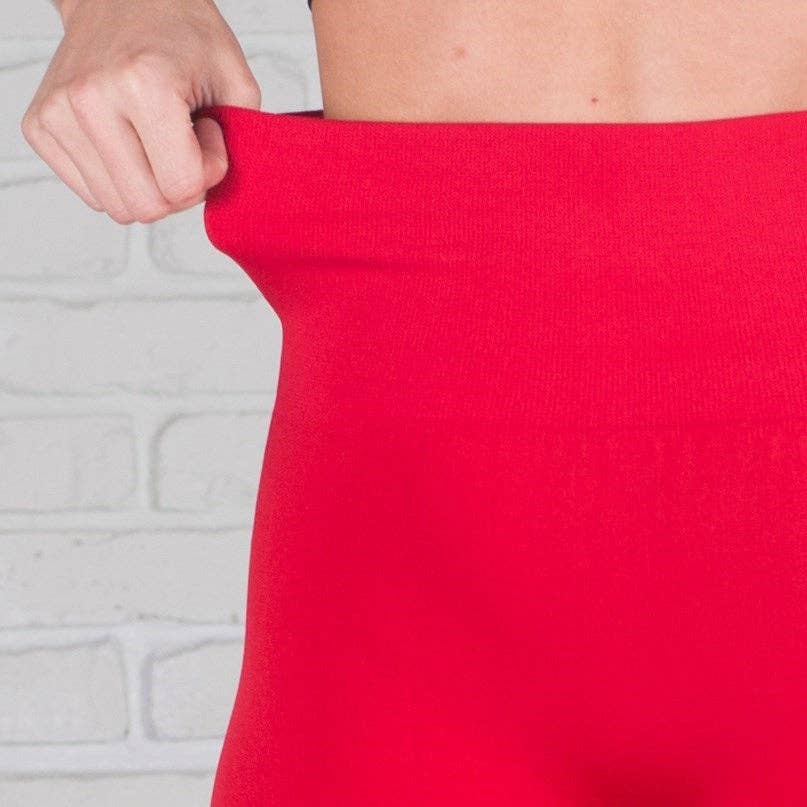 Red fabric held up against a light gray background