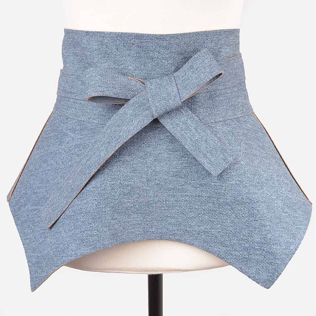 Blue denim skirt with a belt on a mannequin against a white background