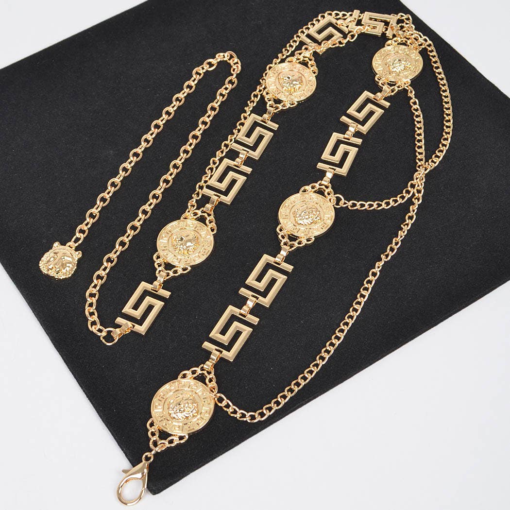 Gold chain necklace with decorative elements on a black background