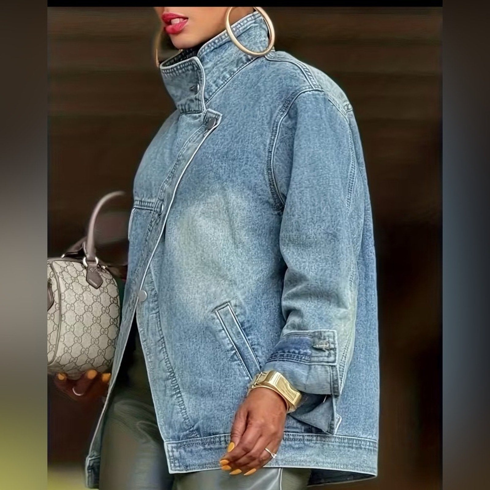Person wearing a denim jacket with a blurred background