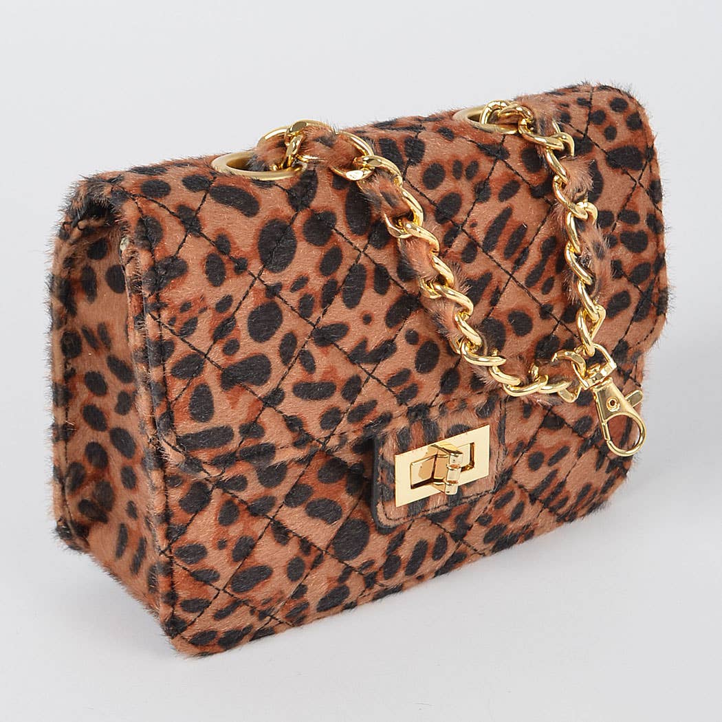 Leopard print handbag with gold chain and clasp on a light gray background