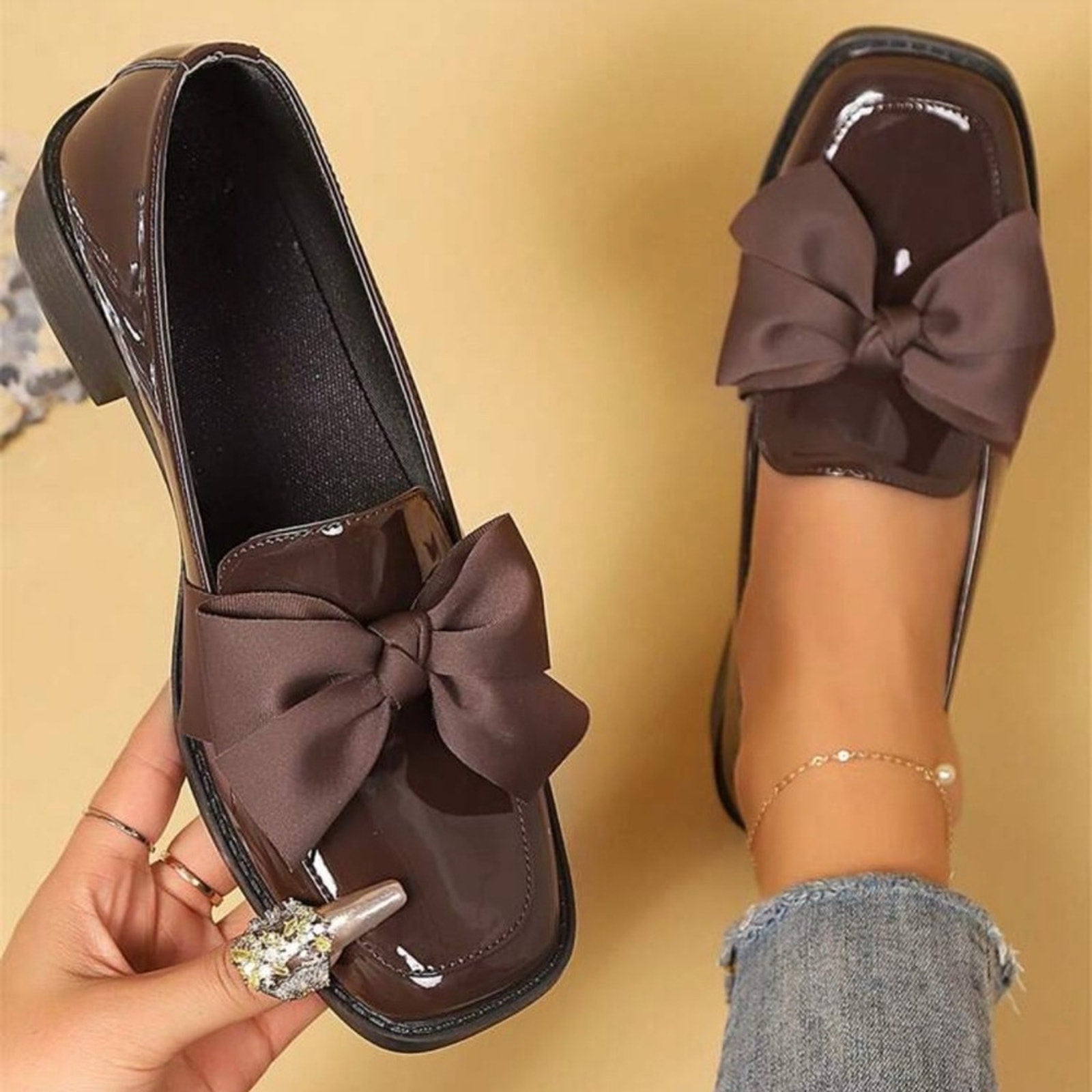 Brown shoes with large bows on a beige background