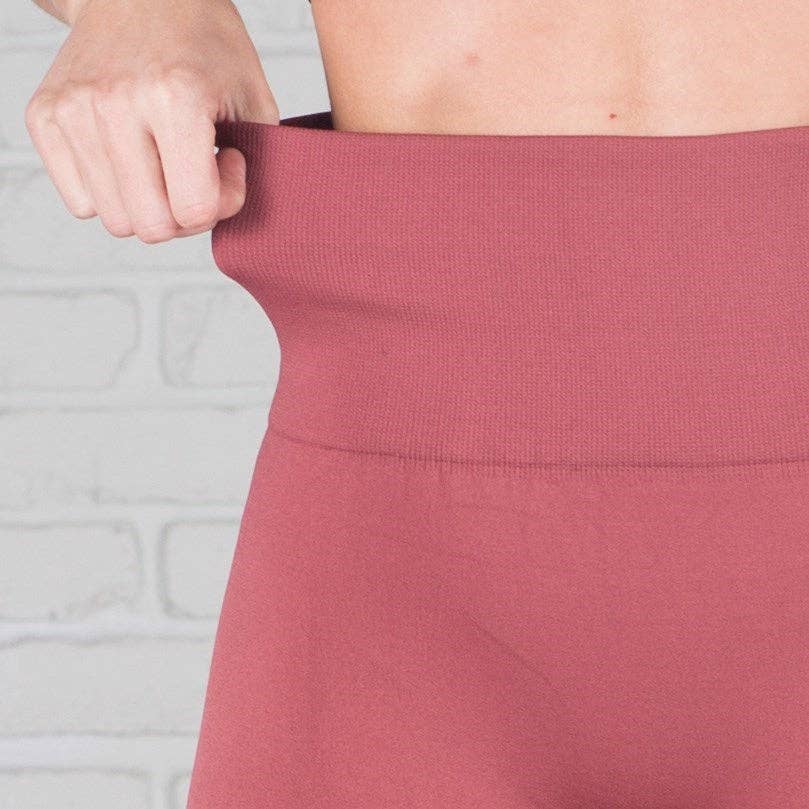 Close-up of a person wearing a pink dress with a blurred background