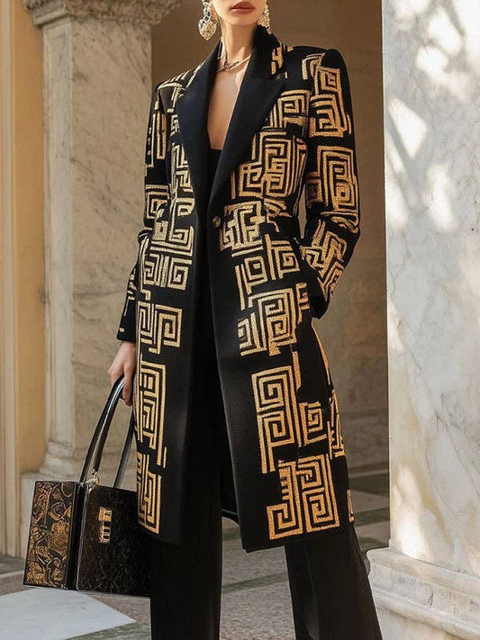 Person wearing a black coat with gold geometric patterns in an elegant setting.