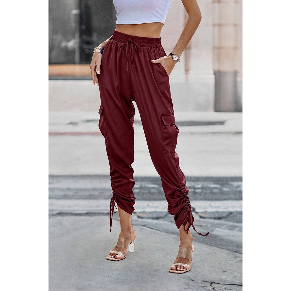 Person wearing maroon cargo pants with a blurred background