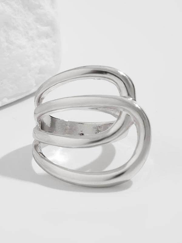 Silver ring with multiple loops on a light gray background
