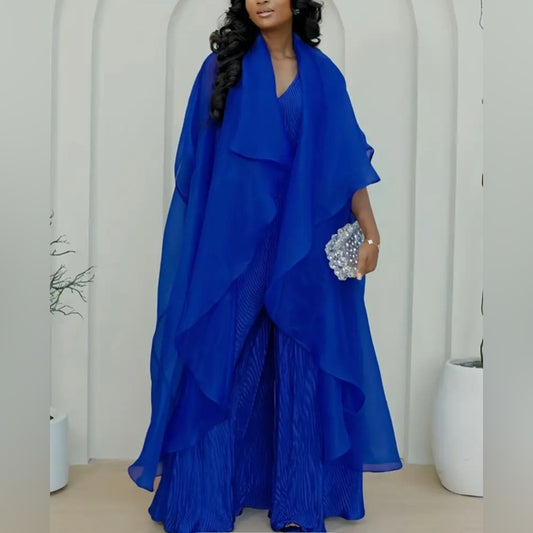 Woman wearing a blue dress with a matching shawl against a white background