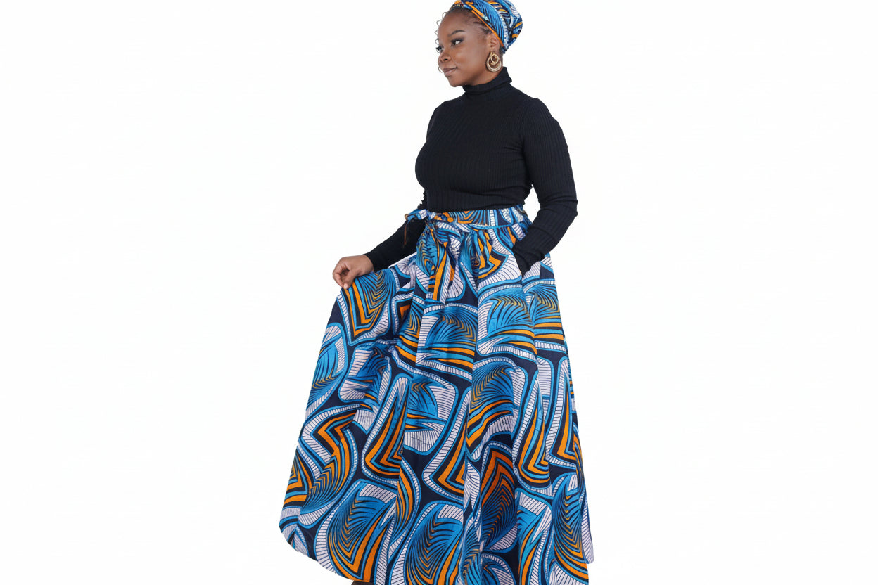 Woman wearing a blue and orange patterned skirt with a black top on a white background