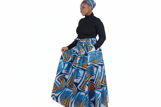 Woman wearing a blue and orange patterned skirt with a black top on a white background