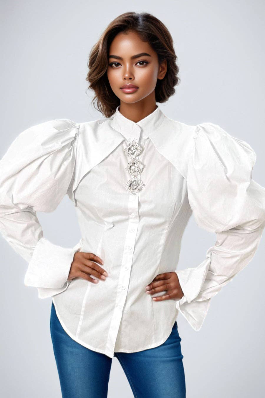 Woman wearing a white blouse with puffed sleeves on a plain background