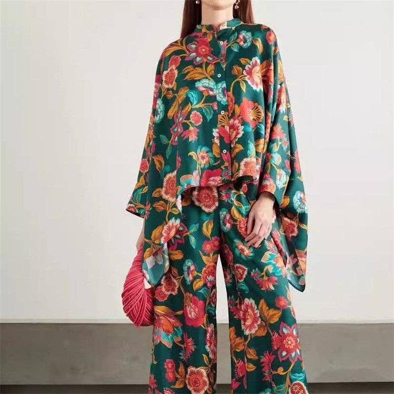 Person wearing a colorful floral outfit with a plain background