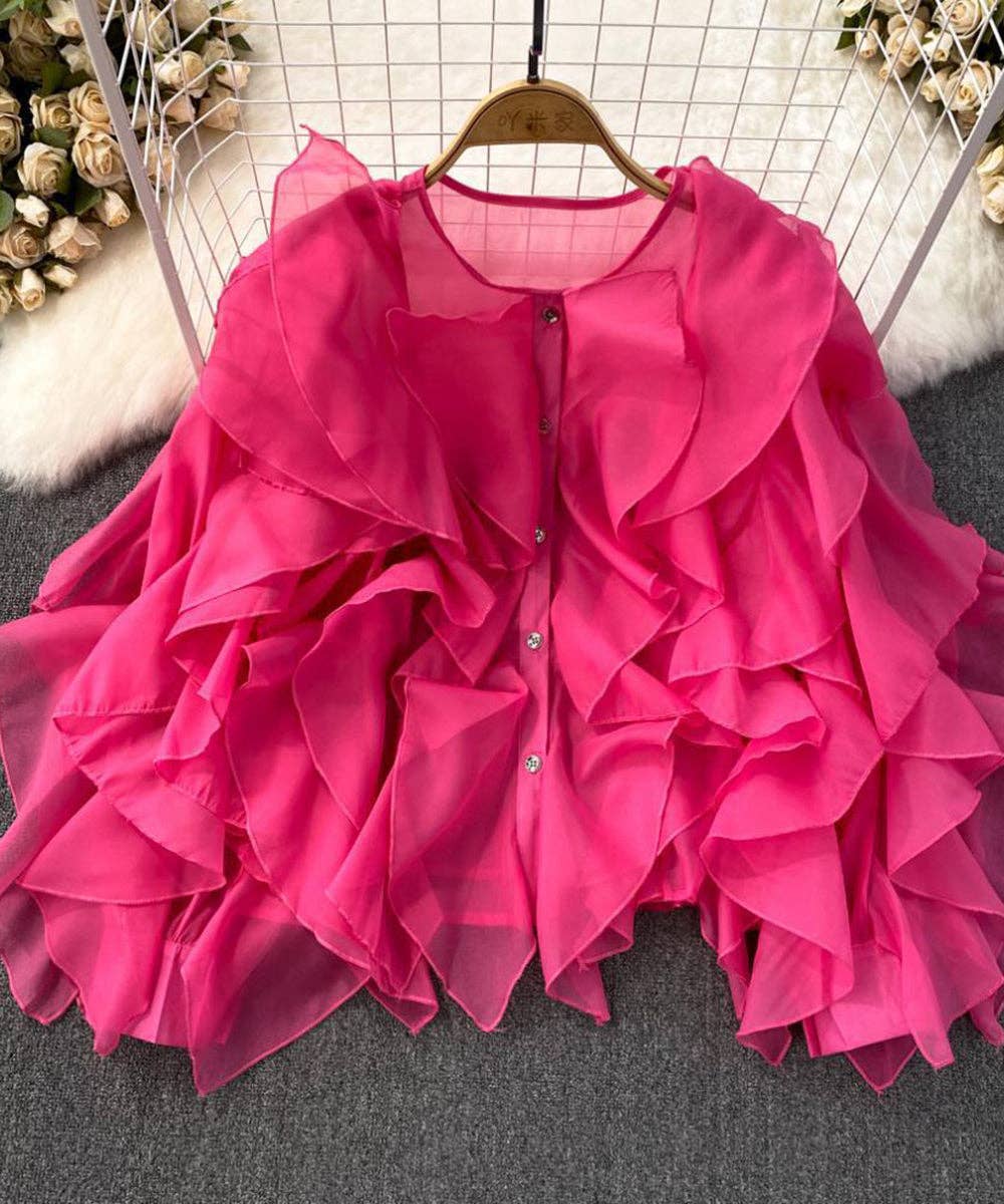 Pink ruffled dress on a hanger with a neutral background