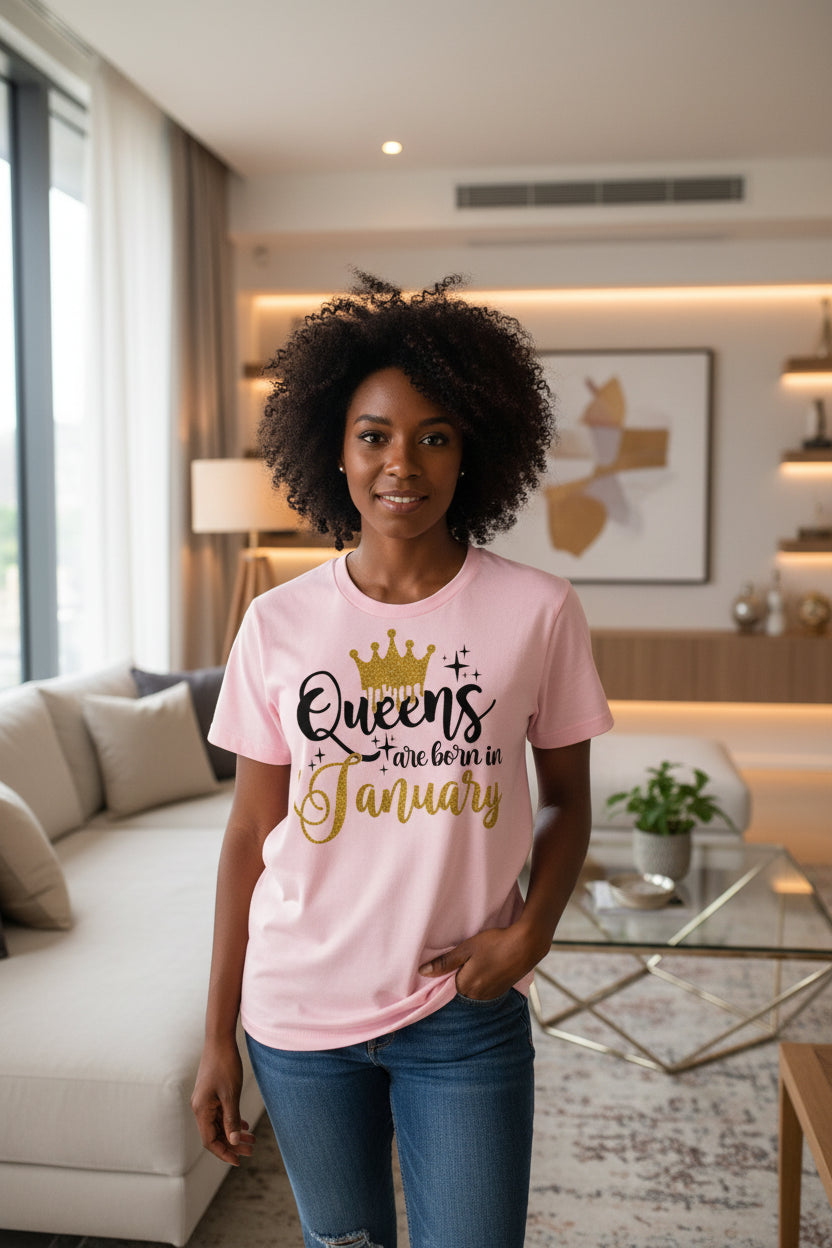 Pink t-shirt with 'Queens are born in January' text and gold crown graphic on a white background.
