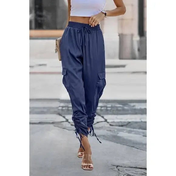 Navy blue cargo pants worn by a person on a blurred street background