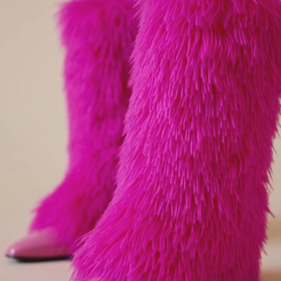 video Pink furry leg warmers worn by a person on a white background