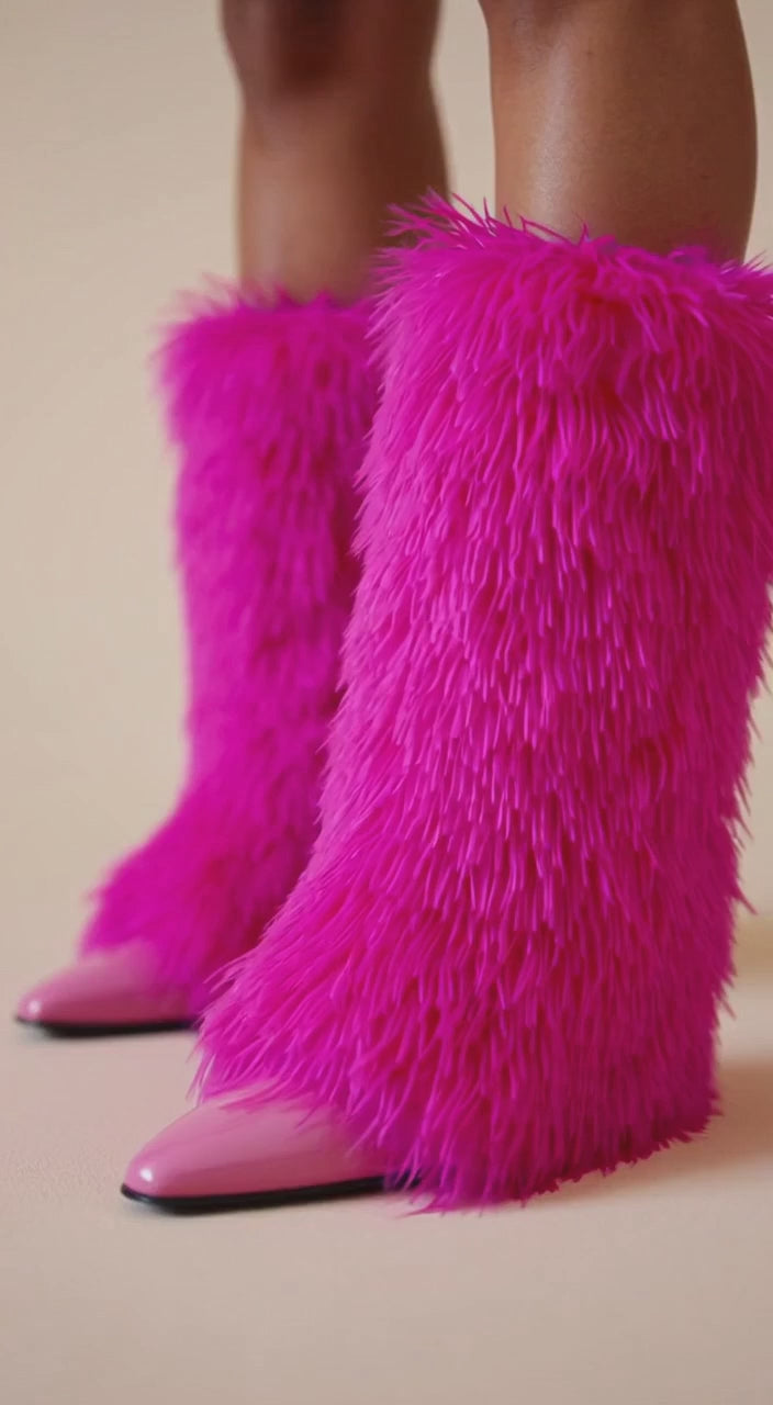video Pink furry leg warmers worn by a person on a white background