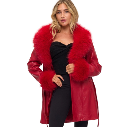 Woman wearing a red fur-trimmed coat on a white background