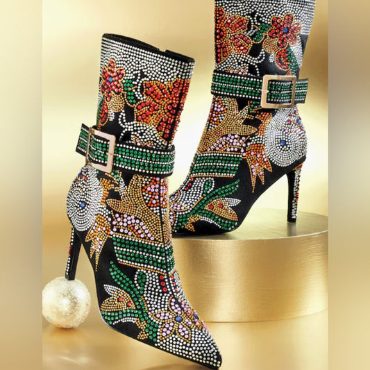 Decorative high-heeled boots with floral patterns and rhinestones on a gold background