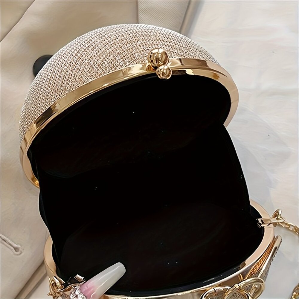 Gold and crystal handbag with open lid showing black interior